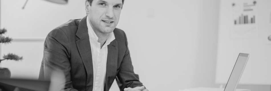 A businessman behind a desk.